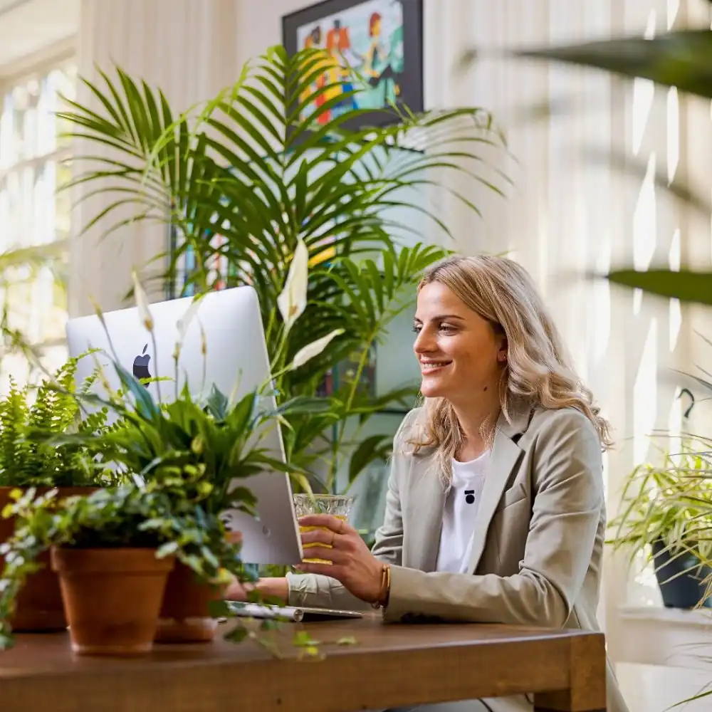 Bright workspace surrounded by lush greenery.